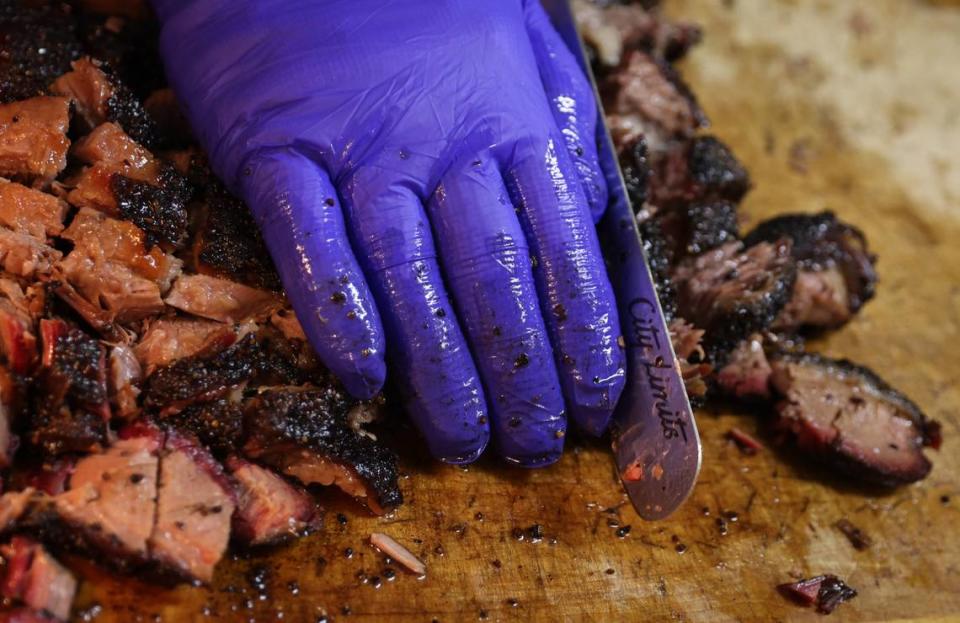 Robbie Robinson, owner of City Limits Barbeque, slices smoked brisket at his West Columbia restaurant on Saturday, March 23, 2024. Robinson is a semifinalist for Best Chef in the southeast in the 2024 James Beard Foundation Awards.