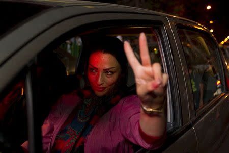 An Iranian woman gestures as she celebrates in the streets following a nuclear deal with major powers, in Tehran July 14, 2015. REUTERS/TIMA