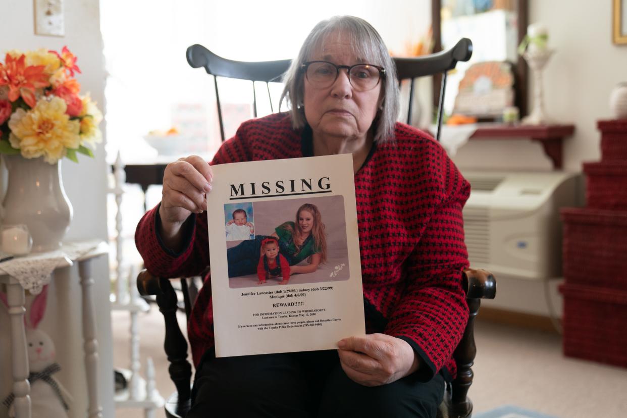 Vicki Lancaster holds up a missing persons poster from 2000 for her then-20-year-old daughter Jennifer Lancaster and two granddaughters 1-year-old Sidney Smith and 5-week-old Monique Smith at her home Thursday afternoon. Nearly 23 years after, Lancaster has little information what happened to her family.