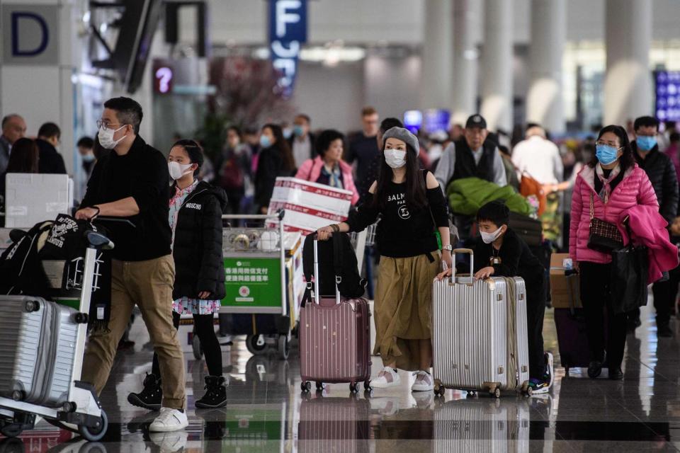 Passengers wear face masks at Hong Kong's international airport (AFP via Getty Images)