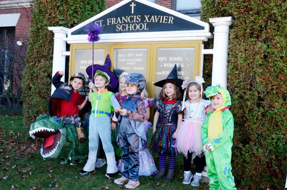 A kindergarten class poses for a photo following the St. Francis Xavier School's annual Halloween parade.