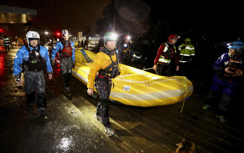 Emergency workers use an inflatable boat in Nelson, New Zealand, Wednesday, Aug. 17, 2022. Heavy rain continued to pelt New Zealand causing further disruptions and road closures from a storm that has already forced hundreds of people to evacuate their homes. (George Heard/New Zealand Herald via AP)