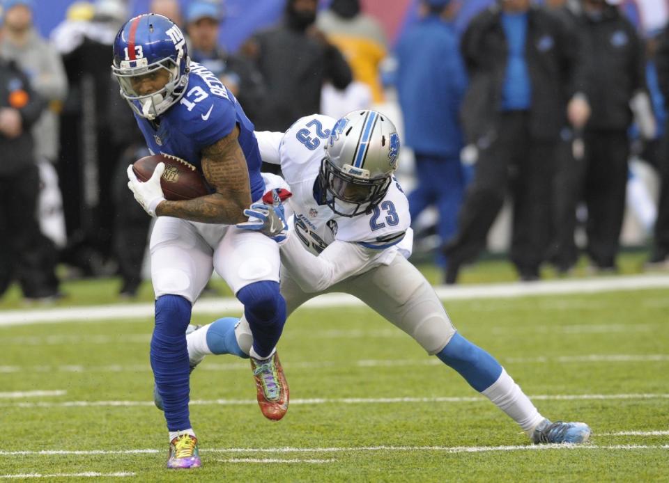 Detroit Lions cornerback Darius Slay (23) tackles New York Giants' Odell Beckham (13) during the first half of an NFL football game Sunday, Dec. 18, 2016, in East Rutherford, N.J. (AP Photo/Bill Kostroun)