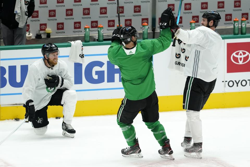 Dallas Stars' Joe Pavelski (16) laughs as Taylor Fedun (42) and Jamie Benn, right, celebrate after their squad won a shoot-out drill during NHL hockey practice in Dallas, Thursday, Jan. 21, 2021. (AP Photo/Tony Gutierrez)