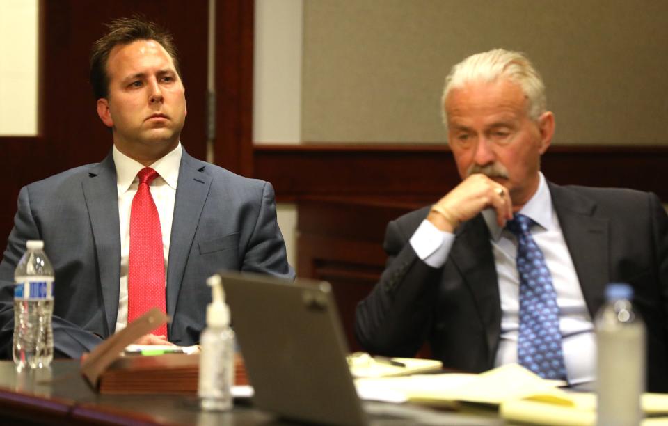 From left, Former assistant prosecutor Derek Miller listens to testimony with his attorney Steve Fishman before his preliminary exam in front of visiting judge Cynthia Arvant inside 41B District Court in Clinton Township on July 9, 2021.