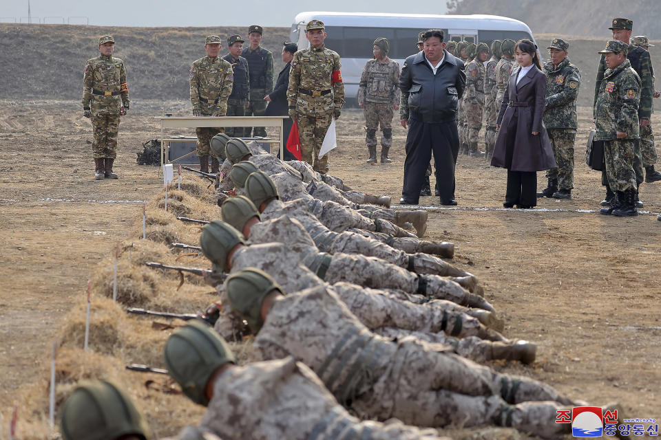 In this photo provided by the North Korean government, North Korean leader Kim Jong Un, standing in front center, and his daughter inspect a training of the Korean People's Army airborne units in North Korea Friday, March 15, 2024. Independent journalists were not given access to cover the event depicted in this image distributed by the North Korean government. The content of this image is as provided and cannot be independently verified. Korean language watermark on image as provided by source reads: "KCNA" which is the abbreviation for Korean Central News Agency. (Korean Central News Agency/Korea News Service via AP)