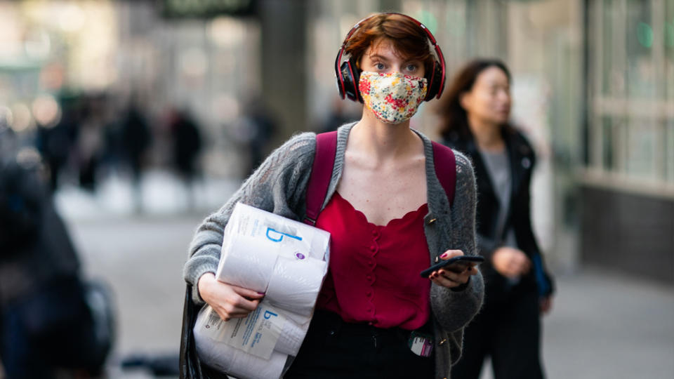 A woman shopping wearing a face mask to prevent the spread of coronavirus.