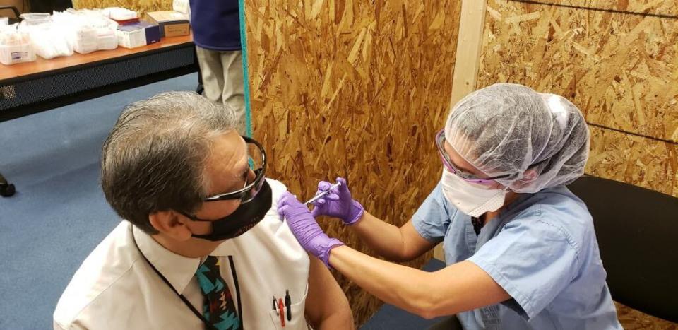 Garland Stiffarm, CEO of Blackfeet Community Hospital in Browning, Mont., receives the Moderna COVID-19 vaccine in December 2020.