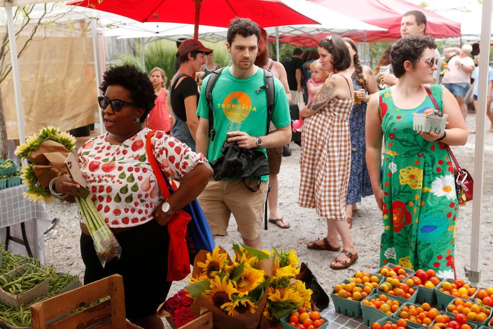 In this file photo from July 14, 2021, author Nicole A. Taylor (far left) is seen among the shoppers at the downtown Athens Farmers Market.