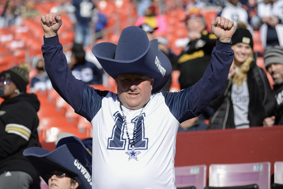 Dallas Cowboys fan in the stands watching pregame warmups prior to the start of the first half of an NFL football game against the Washington Football Team, Sunday, Dec. 12, 2021, in Landover, Md. (AP Photo/Mark Tenally)