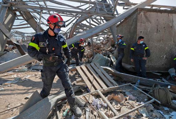 French rescue workers search through the rubble in the devastated Beirut port on Friday (AFP via Getty Images)