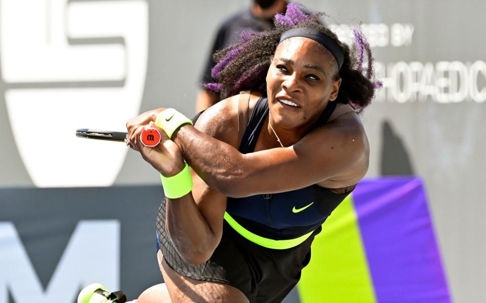 Serena Williams returns a shot to Shelby Rogers  - AP