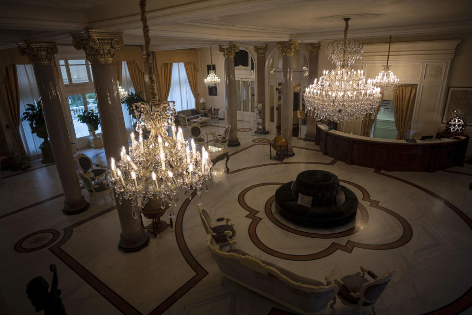 This Monday, May 11, 2020 photo shows an empty foyer of the Rimini Grand Hotel, in Rimini, Italy. The luxury Liberty-style hotel, where carnivalesque Italian director Federico Fellini used to stay, was built in 1908. Parts of the hotel were recreated in Rome's Cinecittà film studios for some of his movies including 'Amarcord' (1973). (AP Photo/Domenico Stinellis)