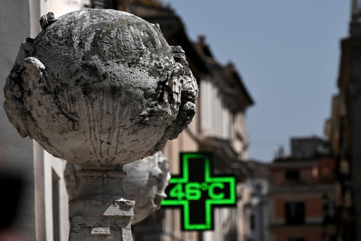 A pharmacy's sign indicates the current outside temperature of 46 degrees Celsius near the Scalinata di Trinita dei Monti (Spanish Steps) in Rome on July 18 (AFP via Getty Images)