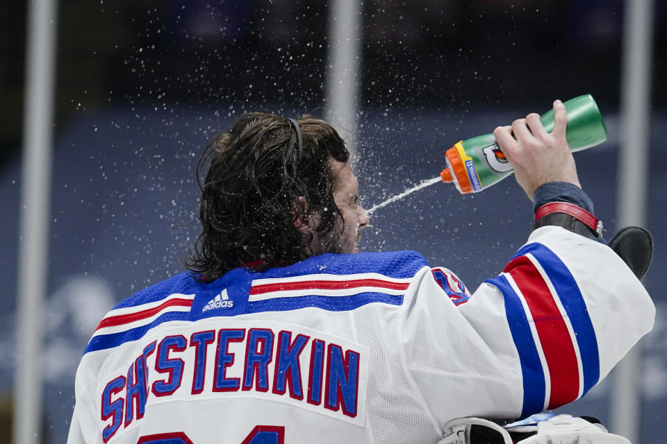 New York Rangers goaltender Igor Shesterkin sprays water onto his face during the second period of the team's NHL hockey game against the New York Islanders on Tuesday, April 20, 2021, in Uniondale, N.Y. (AP Photo/Frank Franklin II)