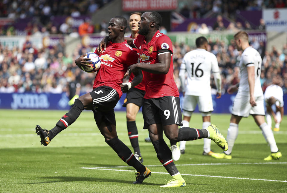 Manchester United’s Eric Bailly, left, celebrates with teammate Romelu Lukaku after scoring his side’s first goal during their English Premier League soccer match at the Liberty Stadium, Swansea, Wales, Saturday, Aug. 19, 2017. (Nick Potts/PA via AP)