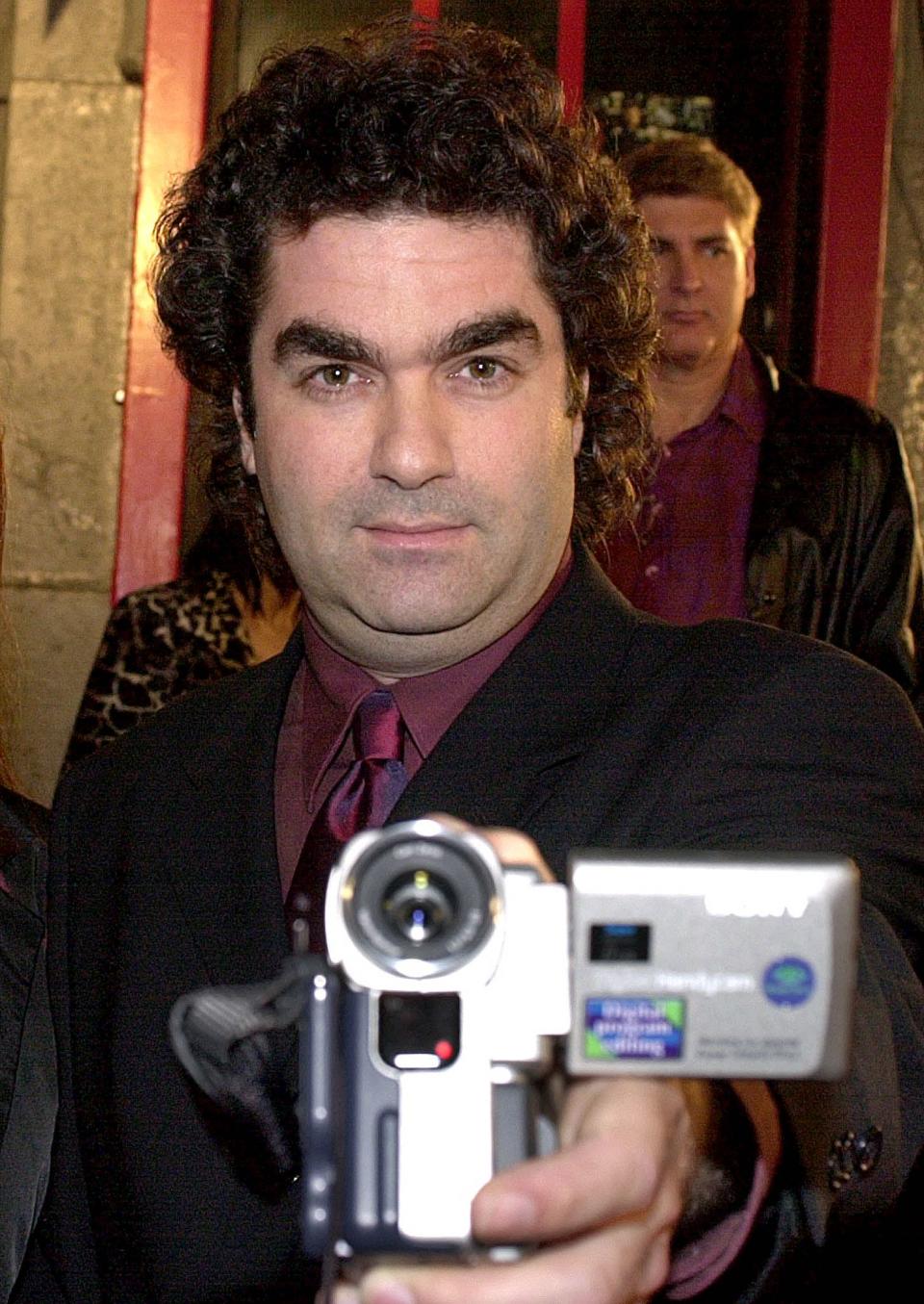 Joe Berlinger films the media as he arrives at the premiere of 