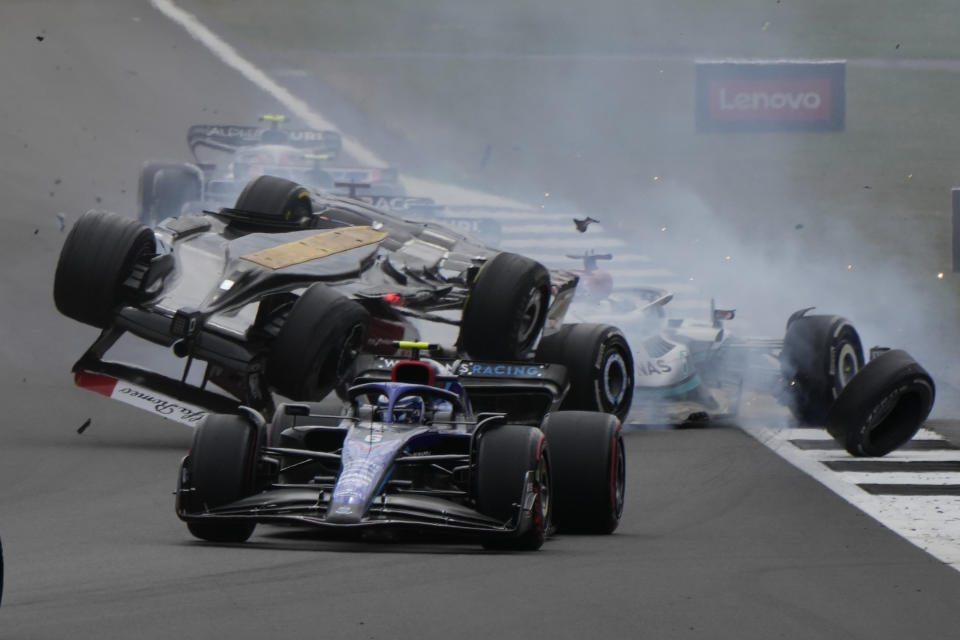 Alfa Romeo driver Guanyu Zhou of China crashes at the start of the British Formula One Grand Prix at the Silverstone circuit, in Silverstone, England, Sunday, July 3, 2022. (AP Photo/Frank Augstein)