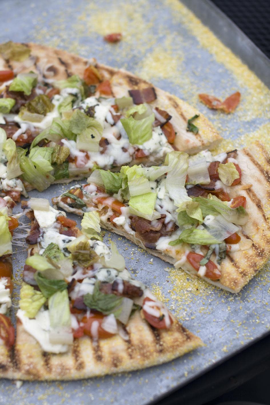 This July 22, 2013 photo taken in Concord, N.H., shows a recipe for grilled BLT pizza with summer tomato-basil sauce. (AP Photo/Matthew Mead)