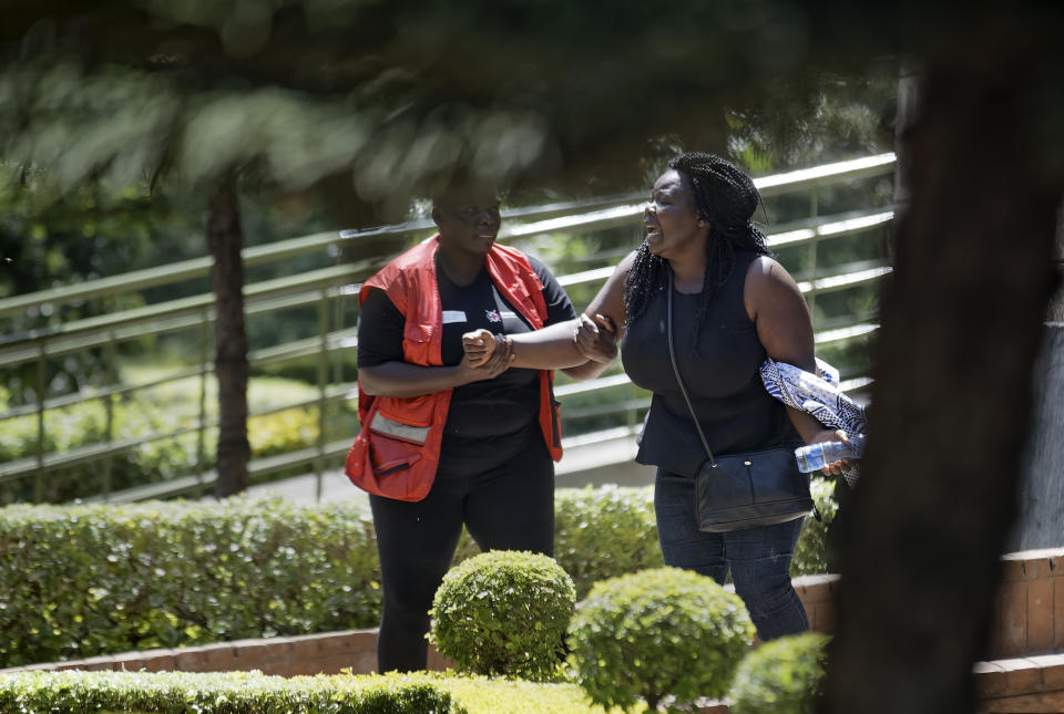 A unidentified relative is helped by a Red Cross worker as she grieves after visiting the morgue in Nairobi, Kenya Thursday, Jan. 17, 2019. Extremists stormed a luxury hotel complex in Kenya's capital on Tuesday, setting off thunderous explosions and gunning down people at cafe tables in an attack claimed by Africa's deadliest Islamic militant group al-Shabab. (AP Photo/Ben Curtis)