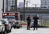 <p>A San Francisco police officer gestures while standing outside a UPS package delivery warehouse where a shooting took place Wednesday, June 14, 2017, in San Francisco. A UPS spokesman says four people were injured in the shooting at the facility and that the shooter was an employee. (AP Photo/Eric Risberg) </p>