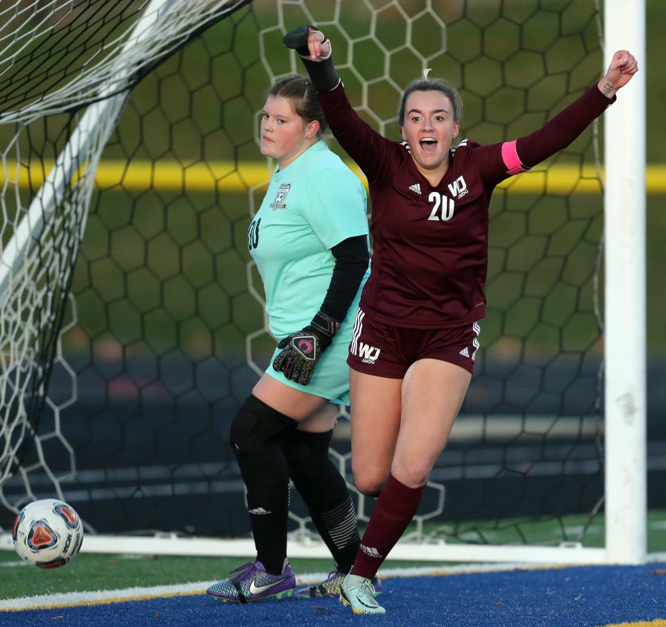Walsh Jesuit's Kayla Flory, front, celebrates her goal as Green goalkeeper Paige Sitko looks on during the first half of a Division I district championship soccer game at NDCL, Thursday, Oct. 27, 2022, in Chardon, Ohio.