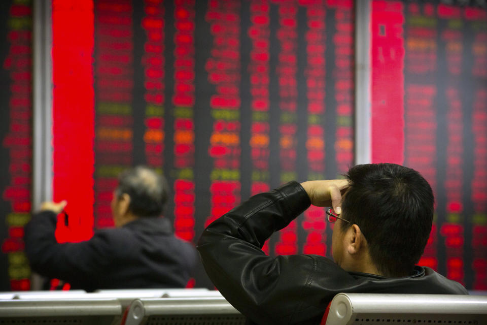 In this Oct. 31, 2018, photo, Chinese investors monitor stock prices at a brokerage house in Beijing. China's government is trying to dispel stock market gloom and talk prices back up with promises of tax cuts and a media campaign led by its economic czar. (AP Photo/Mark Schiefelbein)