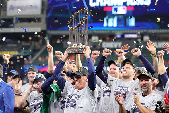 HOUSTON, TEXAS - NOVEMBER 02:  Manager Brian Snitker #43 of the Atlanta Braves hoists the commissioner's trophy following the team's 7-0 victory against the Houston Astros in Game Six to win the 2021 World Series at Minute Maid Park on November 02, 2021 in Houston, Texas. (Photo by Carmen Mandato/Getty Images)