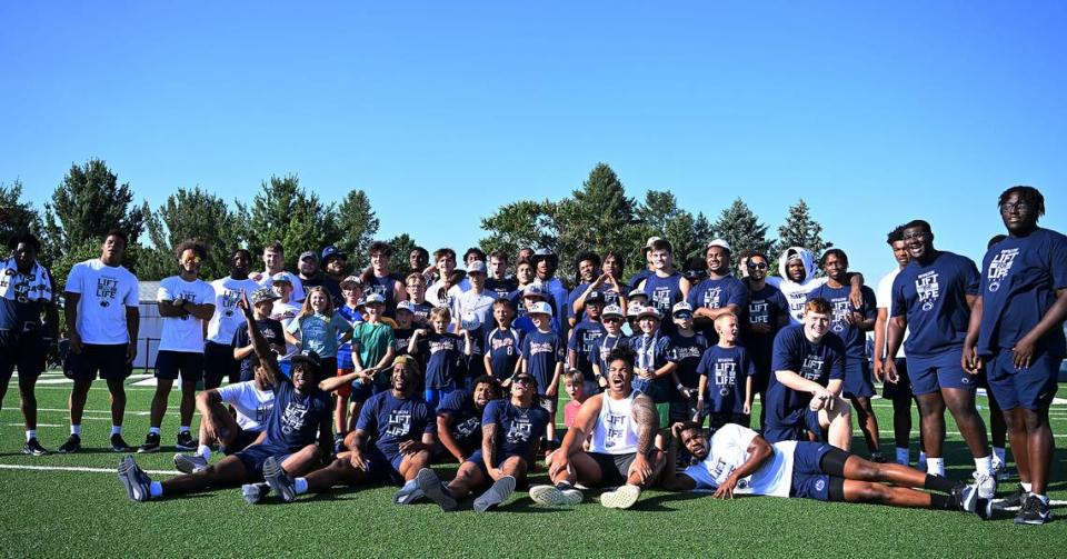 The Penn State football team poses with kids during the Nittany Lions annual Lift For Life event at University Park Thursday, June 30, 2022.