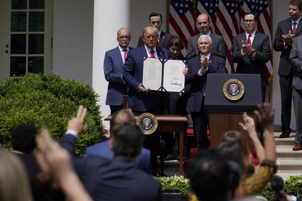 FILE - In this June 5, 2020 file photo, President Donald Trump poses for a photo after signing the Paycheck Protection Program Flexibility Act during a news conference in the Rose Garden of the White House in Washington. Small businesses are in limbo again as the coronavirus outbreak rages and the government’s $659 billion relief program draws to a close. Companies still struggling with sharply reduced revenue are wondering if Congress will give them a second chance at the Paycheck Protection Program, which ends Friday, Aug. 7, after giving out 5.1 million loans worth $523 billion. (AP Photo/Evan Vucci, File)