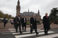 The Gambia delegation leaves the Peace Palace, rear, which houses the International Court in The Hague, Netherlands, Monday, Nov. 11, 2019, after filing a case at the United Nations' highest court accusing Myanmar of genocide in its campaign against the Rohingya Muslim minority. A statement released Monday by lawyers for Gambia says the case also asks the International Court of Justice to order measures "to stop Myanmar's genocidal conduct immediately." (AP Photo/Peter Dejong)