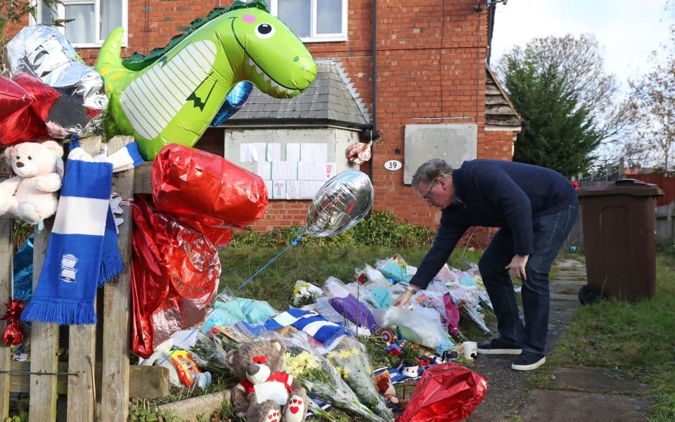 Conservative MP for Solihull Julian Knight leaves flowers outside the home of Arthur Labinjo-Hughes - Bradley Collyer/PA
