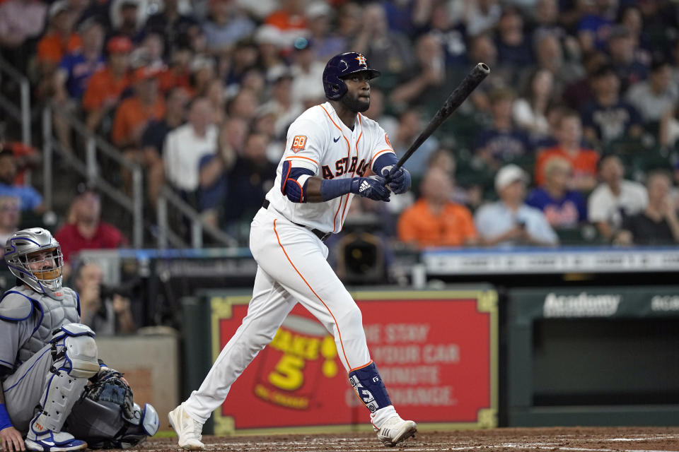 Houston Astros' Yordan Alvarez, right, hits a home run as New York Mets catcher Tomas Nido watches during the third inning of a baseball game Wednesday, June 22, 2022, in Houston. (AP Photo/David J. Phillip)
