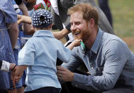 Britain's Prince Harry is greeted by Luke Vincent, 5, on his arrival in Dubbo, Australia, Wednesday, Oct. 17, 2018. Prince Harry and his wife Meghan are on day two of their 16-day tour of Australia and the South Pacific. (Phil Noble/Pool via AP)