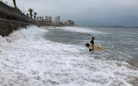 Surfers made the most of a storm swell in Mazatlan - Credit: Daniel Slim/AFP