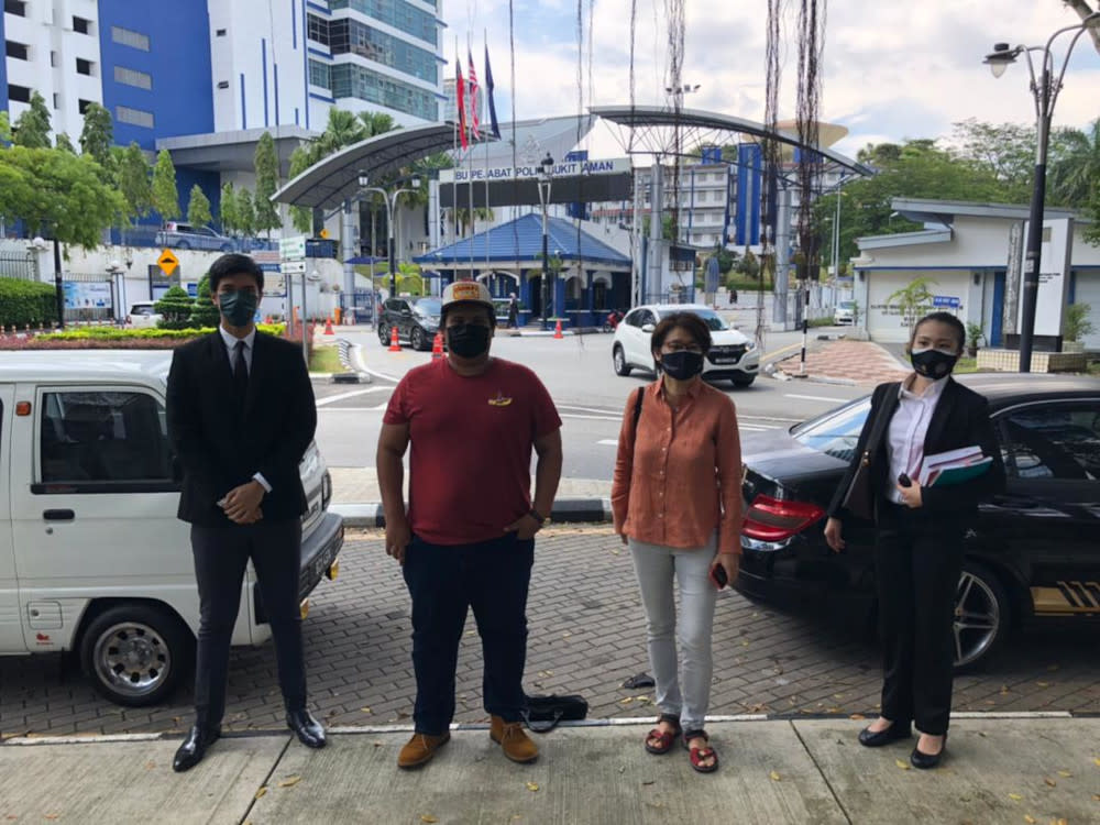 Filmmaker Anna Har (2nd right) and cartoonist Amin Landak (2nd left) with their lawyer Rajsurian Pillai (left) at Bukit Aman, July 2, 2021. — Picture from Twitter/freedomfilmfest