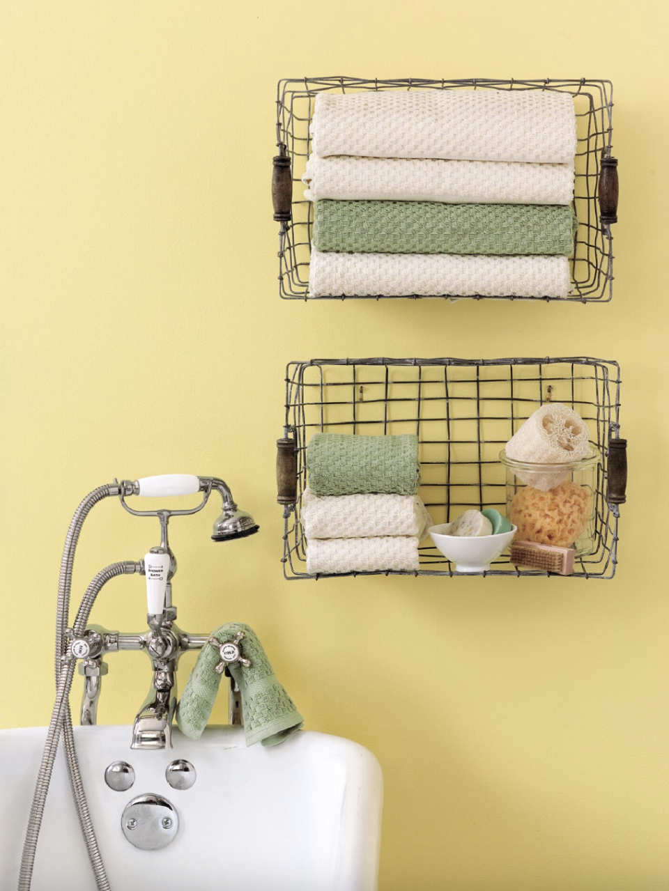 bathroom storage ideas, wire baskets attached to the yellow wall