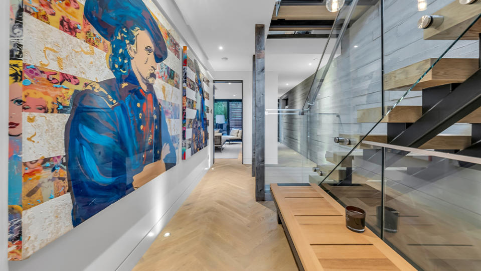 Stylish concrete walls line the entire home including this passage way between floors.