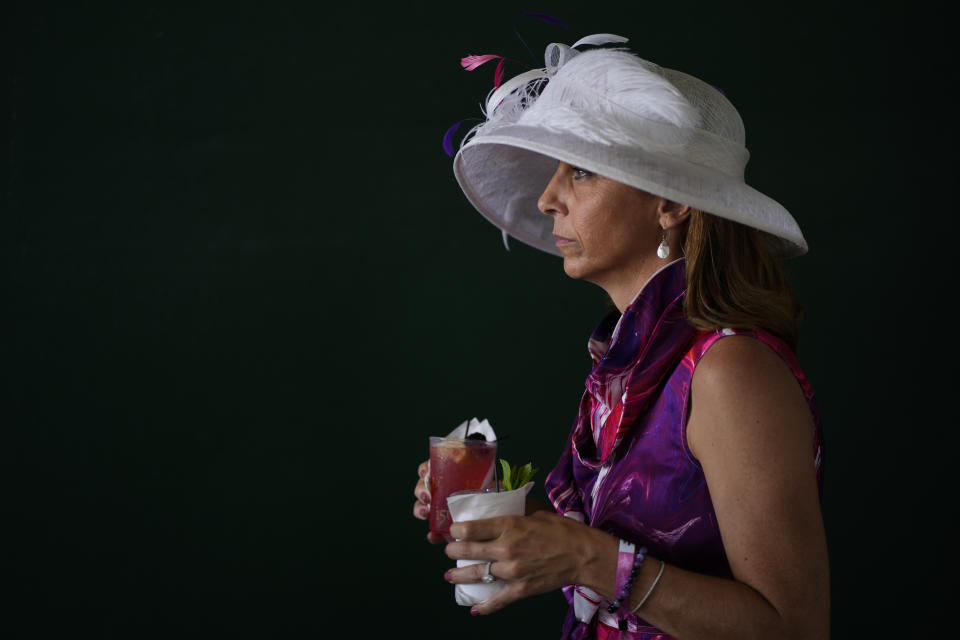 A race fan walks through the grounds of Churchill Downs before the 150th running of the Kentucky Derby horse race Saturday, May 4, 2024, in Louisville, Ky. (AP Photo/Charlie Riedel)