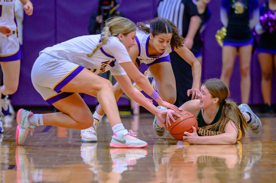 Hickman's Ashtyn Klusmeyer (21), Sy'Rae Stemmons (23) and Rock Bridge's Cora Smith (23) go for a loose ball on Jan. 26, 2023, at Hickman High School.