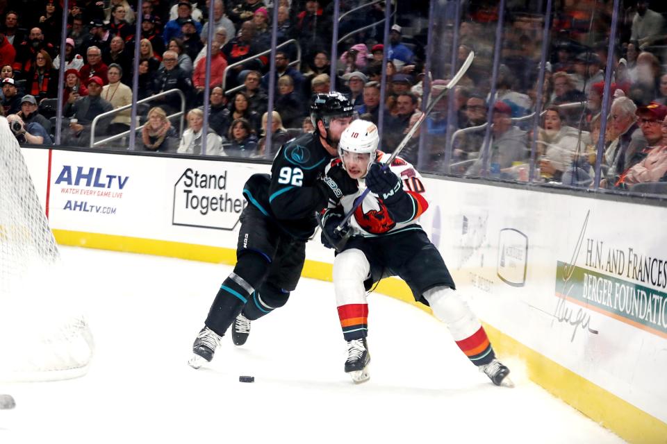 San Jose Barracuda defenseman Darren Brady (92) checks Coachella Valley Firebirds center Luke Henman during the first period at Acrisure Arena in Palm Desert, Calif., on Tuesday, Jan. 10, 2023.