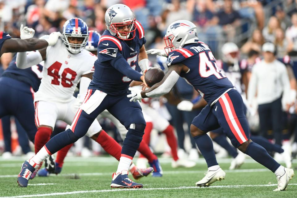 Aug. 11: New England Patriots quarterback Brian Hoyer (5) hands the ball off to running back J.J. Taylor during the first half against the New York Giants at Gillette Stadium.