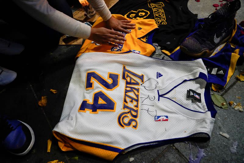 Flowers and memorabilia left as a tribute near the Staples Center to pay respects to Kobe Bryant after a helicopter crash killed the retired basketball star, in Los Angeles