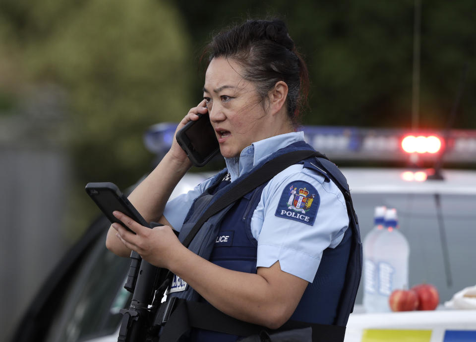 A police officer talks on her phone as a roadblock near a mass shooting at a mosque in Linwood, Christchurch, New Zealand, Friday, March 15, 2019. (Photo: Mark Baker/AP)