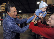 Republican presidential candidate and former Massachusetts Governor Mitt Romney hands six-month-old Dexter back to his mother Laura Hall of Plymouth, MN, after Romney held him for a photograph at a campaign stop in Eagan, Minnesota February 1, 2012. (Craig Lassig/Reuters)