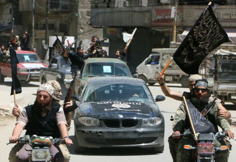 Fighters from Al-Qaeda's Syrian affiliate Al-Nusra Front drive in the northern Syrian city of Aleppo on May 26, 2015