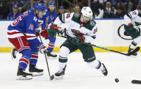 Minnesota Wild's Mats Zuccarello (36) controls the puck in front of New York Rangers' Ryan Strome (16) during the second period of an NHL hockey game Friday, Jan. 28, 2022, in New York. (AP Photo/John Munson)