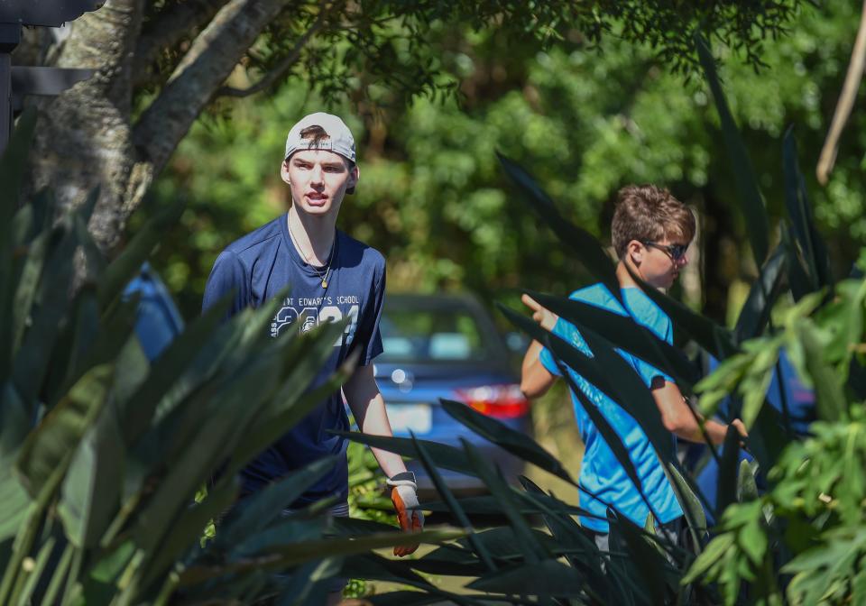 St. Edward’s School seniors Alex Lee, 17 (left), and J.P. Caffrey, 18, help out raking up the trimmed foliage while participating in the Day of Service, helping out at the Shining Light Garden on Saturday, April 13, 2024, in Vero Beach. “I’ve had a little bit of fun today. It was nice to spend time with my classmates and friends and do something that’s good for the community,” Caffrey said. Volunteers provided service in four projects around Indian River County, including packing hygiene kits at the United Against Poverty Center; knitting and crocheting for homeless children at St. Augustine of Canterbury Episcopal Church; and using recycled plastic bags to make mats for the homeless in the community at Temple Beth Shalom. It was organized by Remi Heyer, a senior at Vero Beach High School.