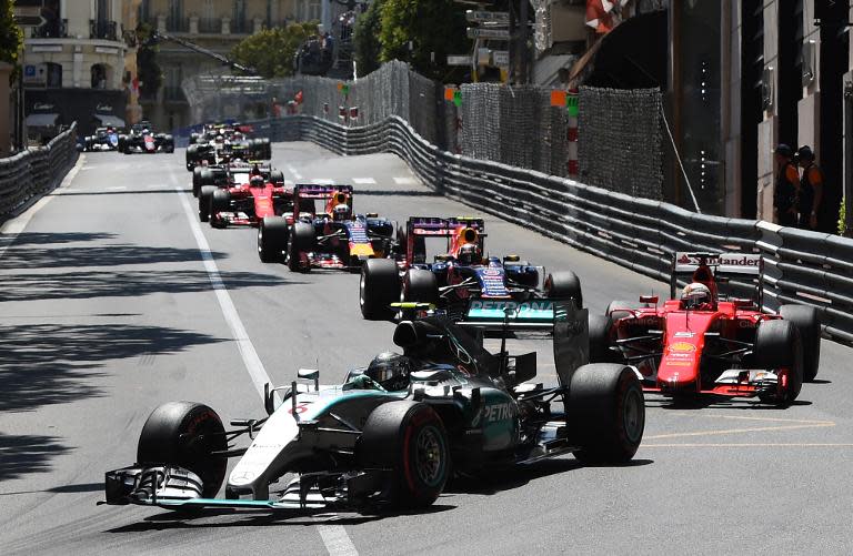 Nico Rosberg (centre) drives in second place, followed by Sebastian Vettel (right) at the start of the Monaco Formula One Grand Prix on May 24, 2015