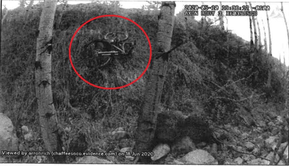 This photo taken from police body cam footage shows Suzanne Morphew's mountain bike after being discovered by sheriff's deputies on the side of a cliff off a road near the family home. / Credit: Chaffee County District Court